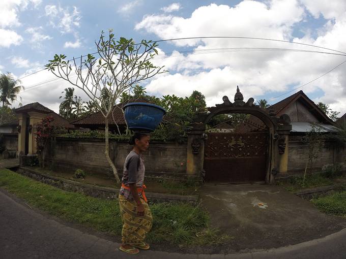 Balinese woman carrying pots on her head