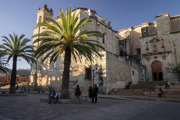 People sitting on the steps of the church