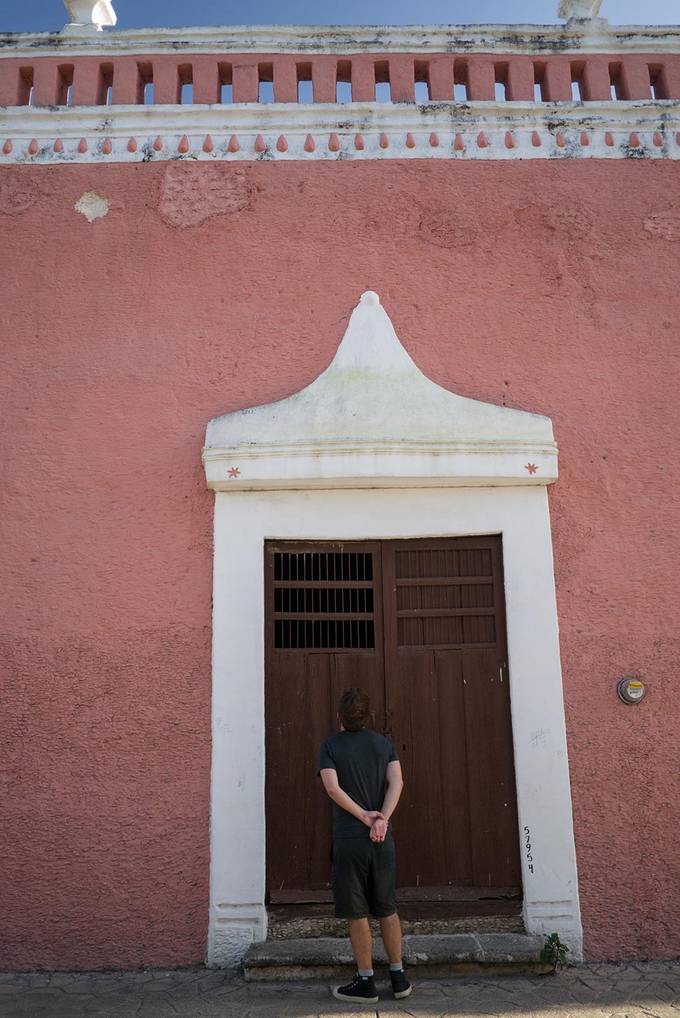 Colin looking up at a red house