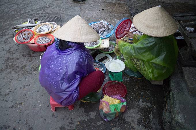 Two women preparing fish